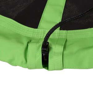 Two children laughing while swinging on the large green outdoor nest swing.