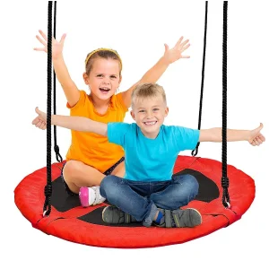 Two children laughing while swinging together on the large red nest swing Ø 100 cm.