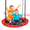 Two children laughing while swinging together on the large red nest swing Ø 100 cm.